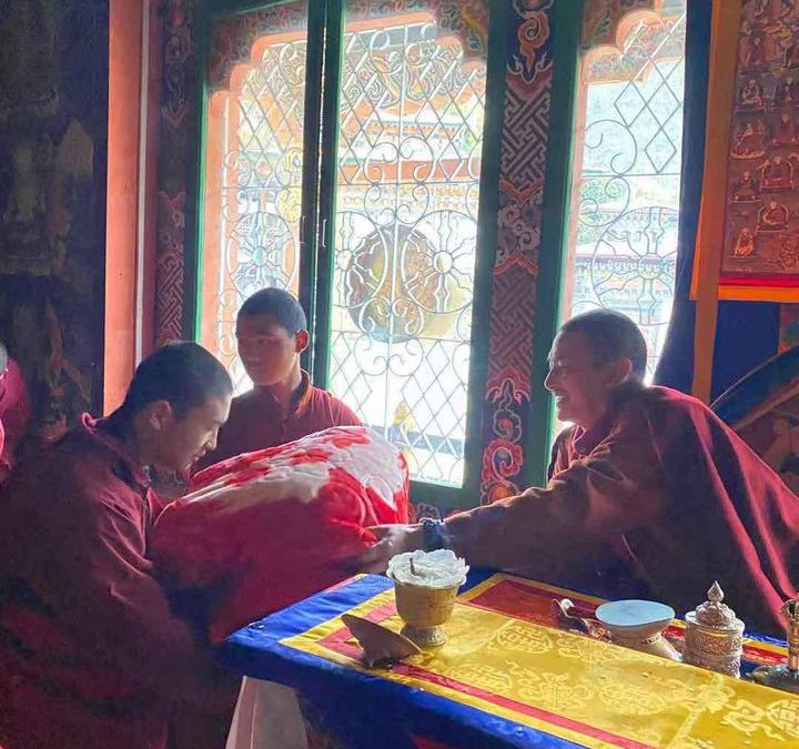 Distribution of blankets to monks